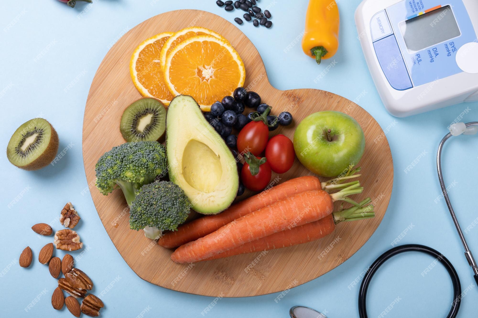 overhead-view-vegetables-fruits-heart-shaped-board-blue-background-copy-space_13339-326055